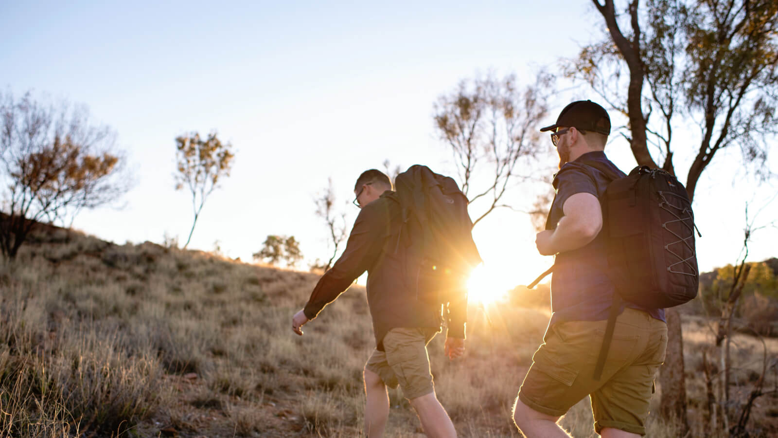 Guys hiking up a hill near Alice Springs